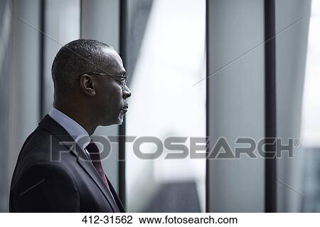 Stock Image - Serious pensive businessman looking away. Fotosearch
