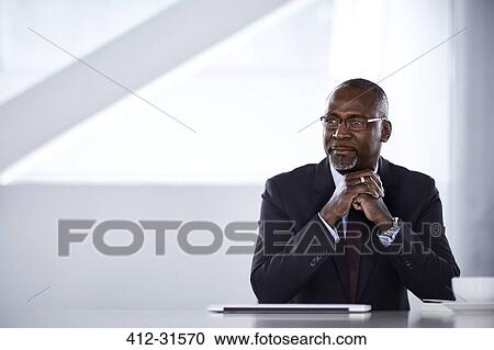 Stock Image - Serious pensive businessman looking away. Fotosearch