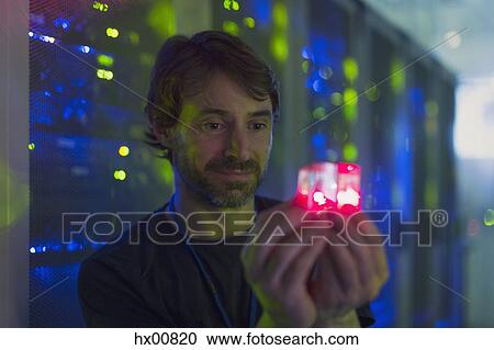 Server room technician holding glowing cube View Large Photo Image Stock Image - Server room technician holding glowing cube. Fotosearch