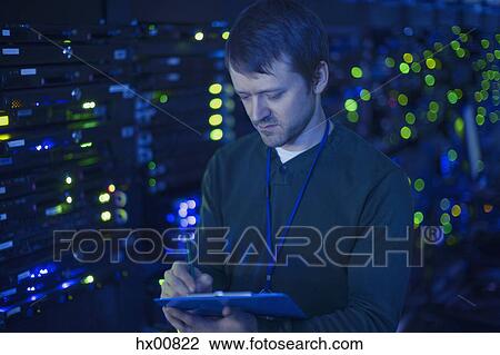 Server room technician taking notes on clipboard View Large Photo Image Stock Image - Server room technician taking notes on clipboard. Fotosearch