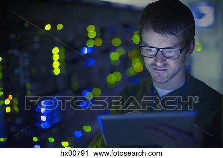 Server room technician using digital tablet View Large Photo Image Stock Image - Server room technician using digital tablet. Fotosearch