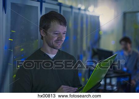 Server room technician using laptop View Large Photo Image Stock Image - Server room technician using laptop. Fotosearch