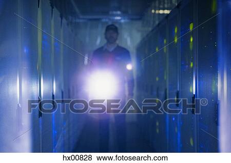 Server room technician with flashlight in dark corridor View Large Photo Image Stock Photo - Server room technician with flashlight in dark corridor. Fotosearch