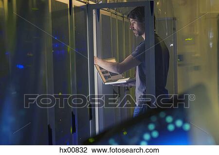 Server room technician with laptop at panel View Large Photo Image Stock Image - Server room technician with laptop at panel. Fotosearch