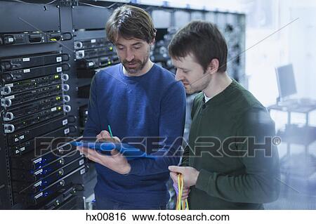 Server room technicians with clipboard View Large Photo Image Stock Photograph - Server room technicians with clipboard. Fotosearch