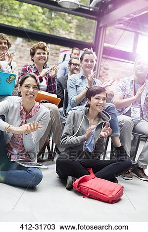 Smiling audience clapping at conference View Large Photo Image Stock Image - Smiling audience clapping at conference. Fotosearch