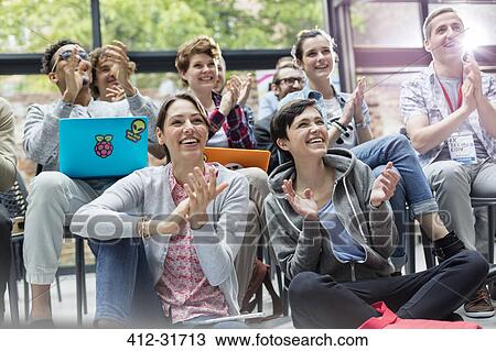 Smiling audience clapping at technology conference View Large Photo Image Stock Image - Smiling audience clapping at technology conference. Fotosearch