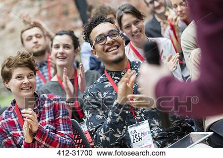 Smiling audience clapping for speaker at technology conference View Large Photo Image Stock Image - Smiling audience clapping for speaker at technology conference. Fotosearch