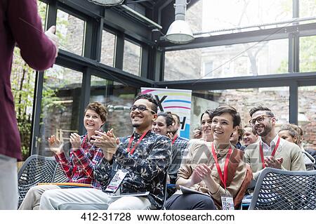Smiling audience clapping for speaker at conference View Large Photo Image Stock Photo - Smiling audience clapping for speaker at conference. Fotosearch