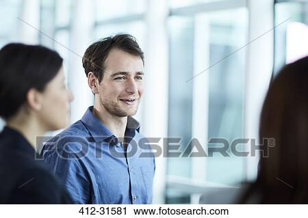 Smiling businessman talking to businesswoman View Large Photo Image Stock Image - Smiling businessman talking to businesswoman. Fotosearch