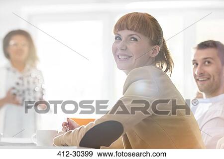 Smiling businesswoman in meeting View Large Photo Image Stock Photo - Smiling businesswoman in meeting. Fotosearch