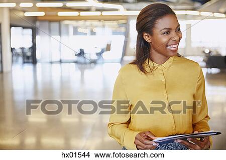 Picture - Smiling businesswoman in office. Fotosearch