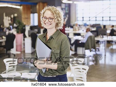 Smiling businesswoman in office View Large Photo Image Picture - Smiling businesswoman in office. Fotosearch
