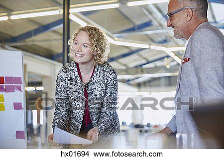 Smiling businesswoman leading meeting in conference room View Large Photo Image Picture - Smiling businesswoman leading meeting in conference room. Fotosearch