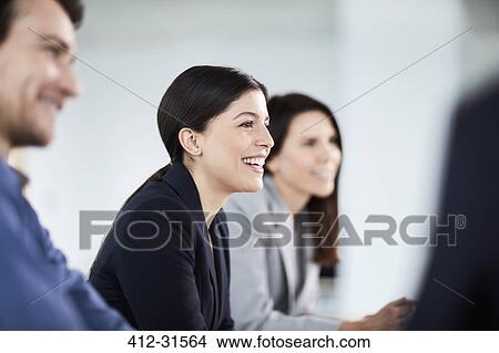 Smiling businesswoman listening in meeting View Large Photo Image Picture - Smiling businesswoman listening in meeting. Fotosearch