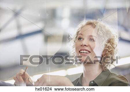 Picture - Smiling businesswoman looking away. Fotosearch