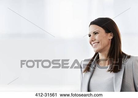 Smiling businesswoman looking away View Large Photo Image Stock Image - Smiling businesswoman looking away. Fotosearch