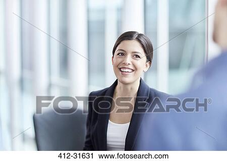 Smiling businesswoman talking to businessman View Large Photo Image Stock Image - Smiling businesswoman talking to businessman. Fotosearch