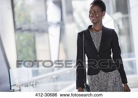 Stock Photograph - Smiling corporate businesswoman looking away. Fotosearch