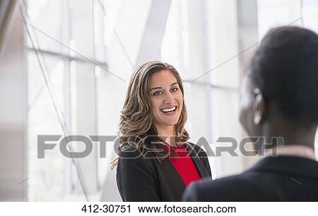 Smiling corporate businesswomen talking View Large Photo Image Stock Image - Smiling corporate businesswomen talking. Fotosearch