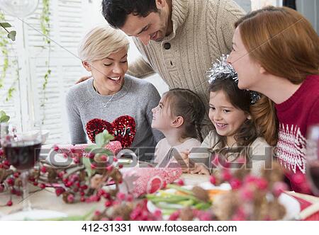 Smiling family at Christmas dinner View Large Photo Image Stock Image - Smiling family at Christmas dinner. Fotosearch