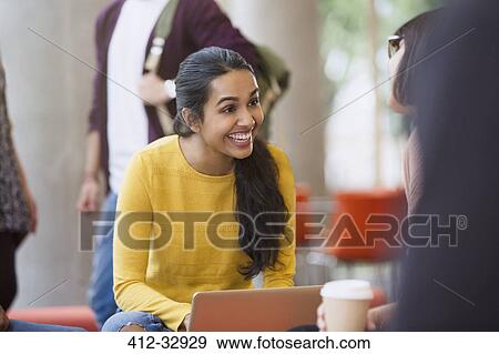 Smiling female college students with coffee and laptop View Large Photo Image Stock Photo - Smiling female college students with coffee and laptop. Fotosearch