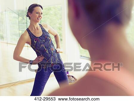 Smiling fitness instructor leading exercise class View Large Photo Image Stock Image - Smiling fitness instructor leading exercise class. Fotosearch