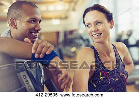 Smiling man and woman resting at gym View Large Photo Image Stock Photography - Smiling man and woman resting at gym. Fotosearch