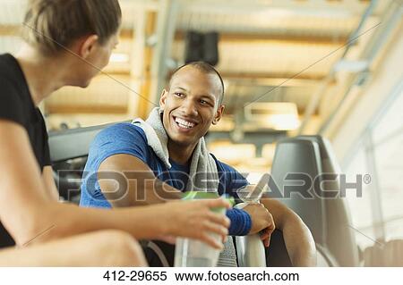 Smiling man and woman talking at gym View Large Photo Image Stock Photography - Smiling man and woman talking at gym. Fotosearch