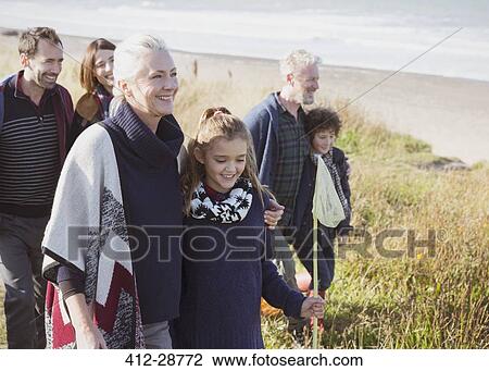 Smiling multi-generation family walking in beach grass View Large Photo Image Stock Image - Smiling multi-generation family walking in beach grass. Fotosearch