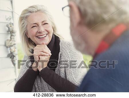 Smiling senior woman talking to man View Large Photo Image Stock Photograph - Smiling senior woman talking to man. Fotosearch