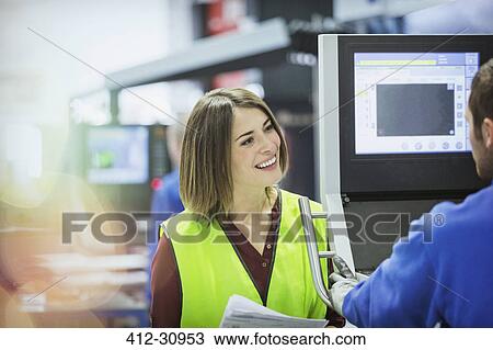 Smiling supervisor and worker at control panel in steel factory View Large Photo Image Stock Image - Smiling supervisor and worker at control panel in steel factory. Fotosearch