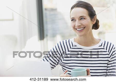 Smiling woman drinking coffee View Large Photo Image Stock Photo - Smiling woman drinking coffee. Fotosearch