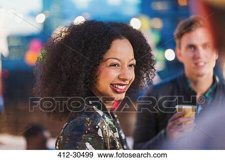 Smiling woman enjoying party View Large Photo Image Stock Photo - Smiling woman enjoying party. Fotosearch
