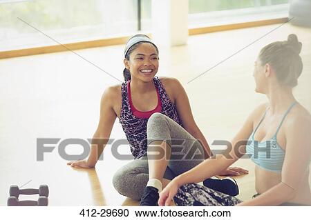 Smiling women talking in gym studio View Large Photo Image Stock Image - Smiling women talking in gym studio. Fotosearch