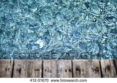 Stock Image - Sparkling blue water below deck. Fotosearch