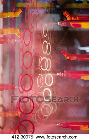 Steel rings being painted red in steel factory View Large Photo Image Stock Photography - Steel rings being painted red in steel factory. Fotosearch