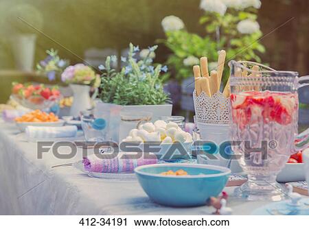 Strawberry water and desserts on garden party patio table View Large Photo Image Stock Image - Strawberry water and desserts on garden party patio table. Fotosearch