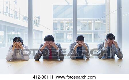 Stressed business people with heads in hands at conference table View Large Photo Image Stock Image - Stressed business people with heads in hands at conference table. Fotosearch