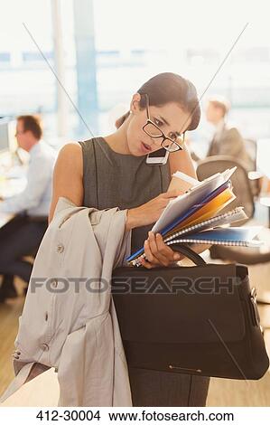 Stressed businesswoman struggling to multitask in office View Large Photo Image Picture - Stressed businesswoman struggling to multitask in office. Fotosearch