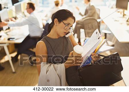 Stressed businesswoman struggling to multitask in office View Large Photo Image Stock Image - Stressed businesswoman struggling to multitask in office. Fotosearch