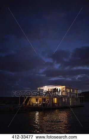 Summer houseboat illuminated on night ocean View Large Photo Image Stock Photo - Summer houseboat illuminated on night ocean. Fotosearch