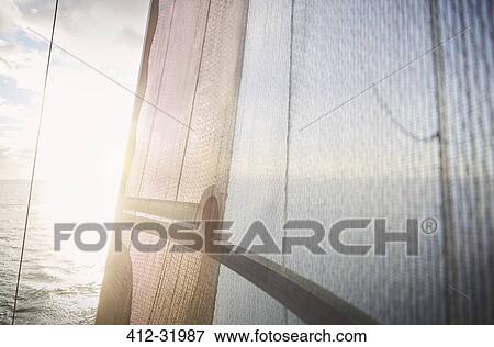 Sun shining against sailboat sail View Large Photo Image Stock Photo - Sun shining against sailboat sail. Fotosearch