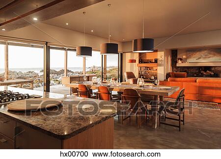 Stock Image - Sunny home showcase interior overlooking ocean. Fotosearch