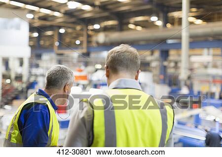 Supervisor and worker in steel factory View Large Photo Image Stock Image - Supervisor and worker in steel factory. Fotosearch