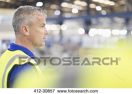 Supervisor looking away in steel factory View Large Photo Image Stock Photo - Supervisor looking away in steel factory. Fotosearch
