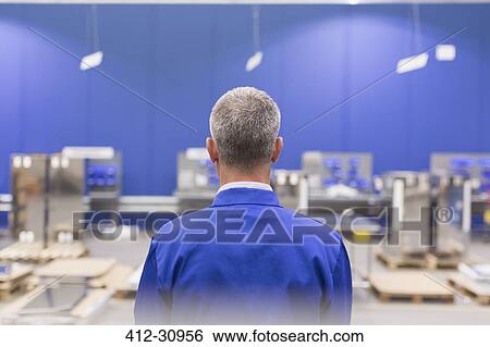 Stock Photograph - Supervisor watching steel plant. Fotosearch