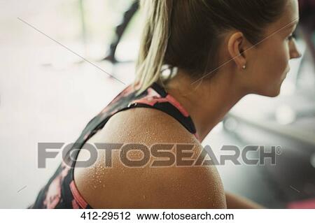 Sweating woman resting at gym View Large Photo Image Stock Image - Sweating woman resting at gym. Fotosearch