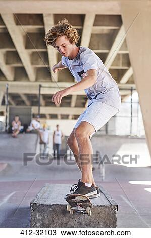 Teenage boy skateboarding at skate park View Large Photo Image Stock Image - Teenage boy skateboarding at skate park. Fotosearch
