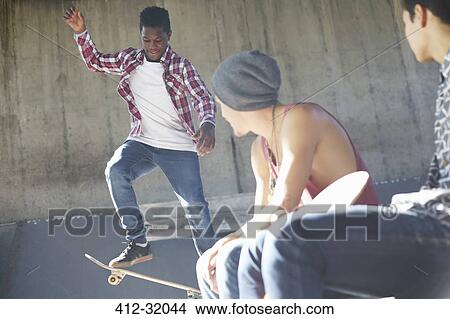 Teenage boys skateboarding at skate park View Large Photo Image Picture - Teenage boys skateboarding at skate park. Fotosearch